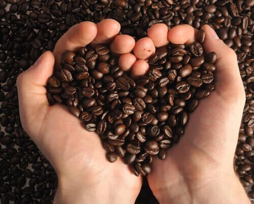 За отстраняване на черни точки: две ръце, във формата на сърце, държат зърна от кафе