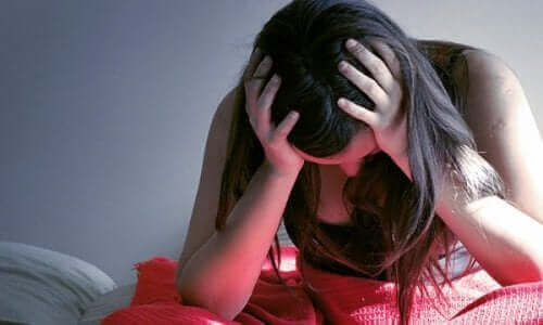 Посттравматичен стрес: една стресирана жена се държи за главата