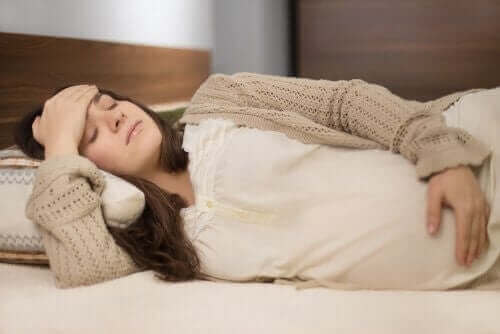 Пренаталният масаж: една бременна жена лежи в легло