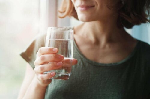 Измислици за коронавируса: жена държи чаша вода